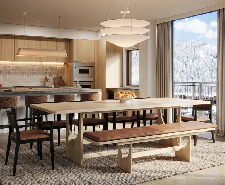 Kitchen and dining room with a long wood table and mountain views